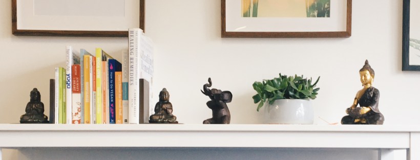 Yoga studio office; shelf with ornaments, posters and yoga towels