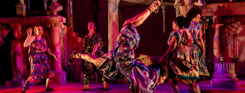 Women in bright togas dancing