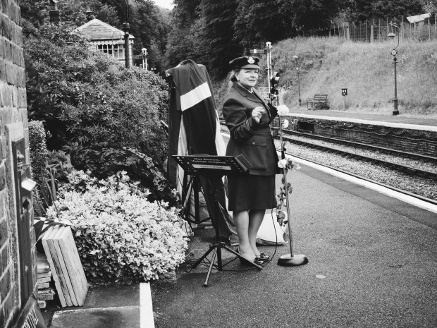 A vintage singer at a station, in uniform