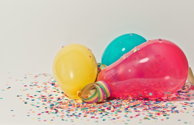 brightly coloured balloons with multicoloured confetti